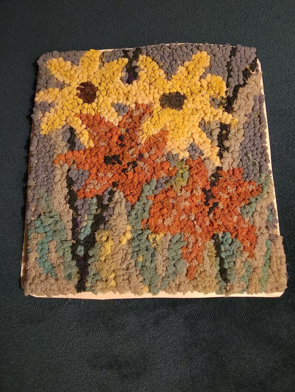 Vintage latch hook, rya-style textile craft featuring a floral design.